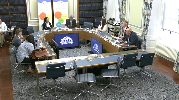 Members of the Committee for The Executive Office sitting in a committee room in Parliament Buildings