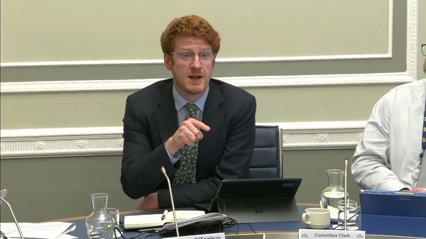 Committee Chair Matthew O'Toole sitting in a committee room in Parliament Buildings