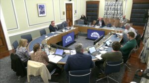 Members of the Committee for Infrastructure sitting in a committee room in Parliament Buildings