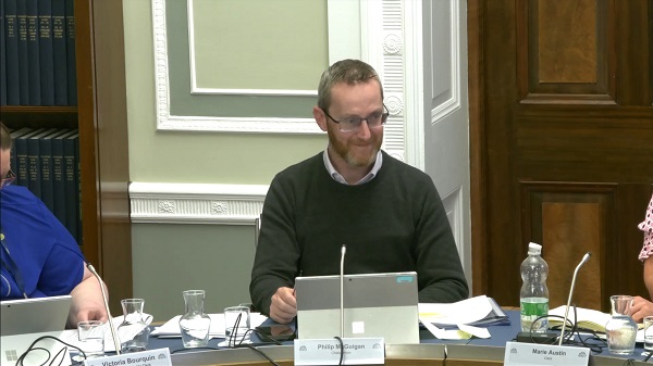 Committee Chair Philip McGuigan sitting in a committee room in Parliament Buildings