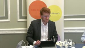 Committee Chair Matthew O'Toole sitting in a committee room in Parliament Buildings