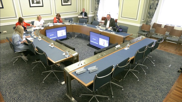 Members of the Committee on Procedures sitting in a committee room in Parliament Buildings