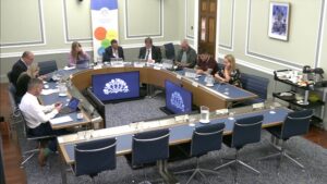 Members of the Education Committee sitting in a committee room in Parliament Buildings