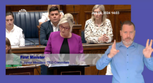 First Minister Michelle O'Neill answering questions on behalf of the Executive Office during Question Time on Monday 24 June 2024. An ISL interpreter is signing in the foreground.