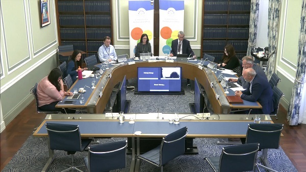 Members of the Executive Office Committee sitting in a committee room in Parliament Buildings