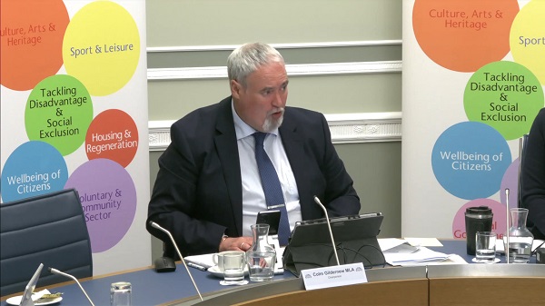 Colm Gildernew, Chair of the Communities Committee sitting in a committee room in Parliament Buildings