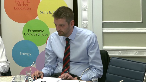 Economy Committee Chairperson Phillip Brett sitting in a committee room in Parliament Buildings