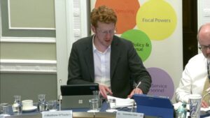 Committee Chair Matthew O'Toole sitting in a committee room in Parliament Buildings