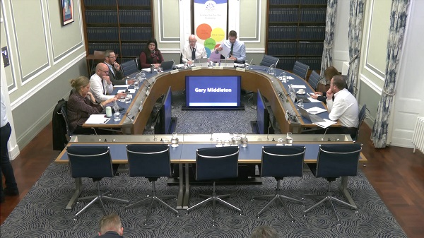 Members of Committee for the Economy sitting in a committee room in Parliament Buildings