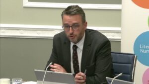 Committee Chair Nick Mathison sitting in a committee room in Parliament Buildings