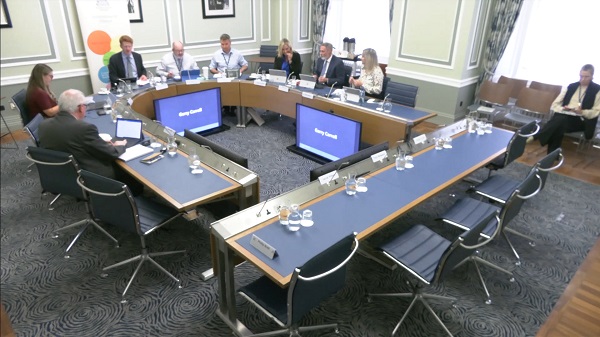 Members of Committee for Finance sitting in a committee room in Parliament Buildings