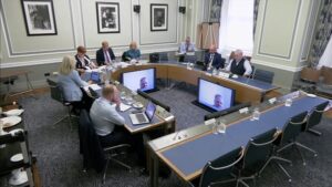 Members of the Public Accounts Committee sitting in a committee room in Parliament Buildings.