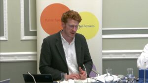 Committee Chair Matthew O'Toole sitting in a committee room in Parliament Buildings