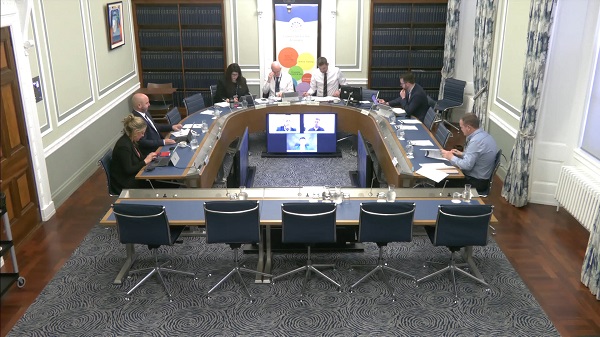 Members of the Economy Committee sitting in a committee room in Parliament Buildings.