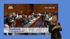 The Assembly Chamber during Question Time on Monday 21 October 2024. In the foreground is a British Sign Language interpreter interpreting the questions and answers.