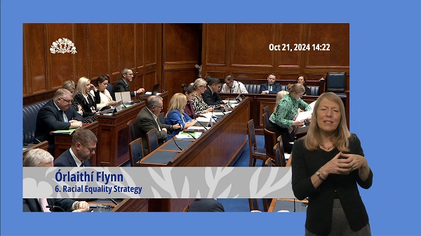 The Assembly Chamber during Question Time on Monday 21 October 2024. In the foreground is a British Sign Language interpreter interpreting the questions and answers.
