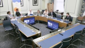 Members of the Finance Committee sitting in a committee room in Parliament Buildings.