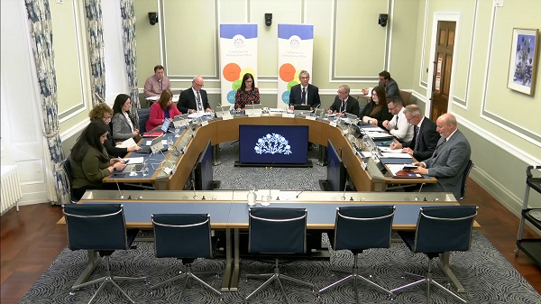 Members of the Committee sitting in a committee room in Parliament Buildings.