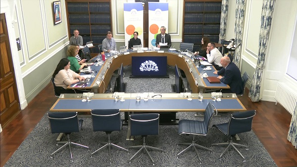Members of the Executive Office Committee sitting in a committee room in Parliament Buildings.