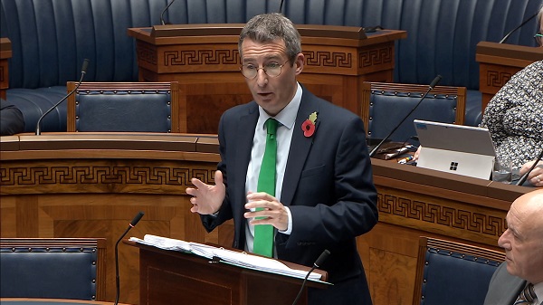 Minister Andrew Muir answers questions in the Assembly Chamber