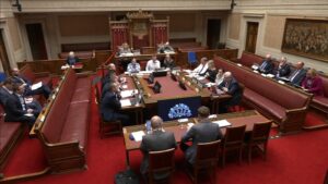 The Concurrent Committee sitting around a table in the Senate Chamber in Parliament Buildings. They are receiving a briefing from Ulster Farmers' Union.