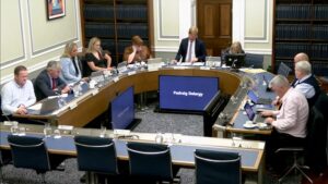 Members of the Committee sitting in a committee room in Parliament Buildings.