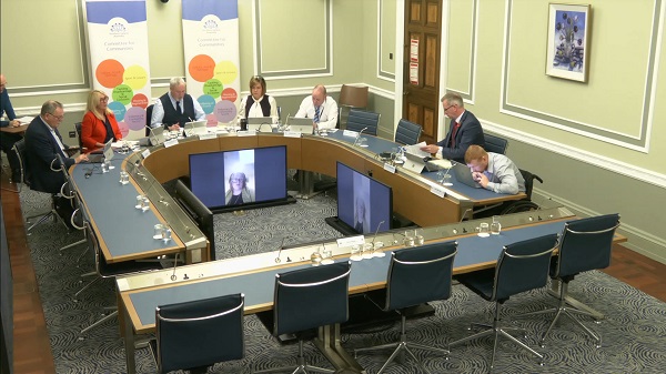Members of the Committee sitting in a committee room in Parliament Buildings.