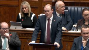 Communities Minister Gordon Lyons answers questions in the Assembly Chamber