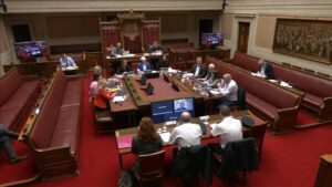 The Concurrent Committee of the Committee for Justice and the Committee for Health sitting around a table in the Senate Chamber in Parliament Buildings. They are receiving oral evidence from PSNI.