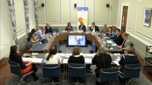 Members of the Committee sitting in a committee room in Parliament Buildings. They are receiving oral evidence.