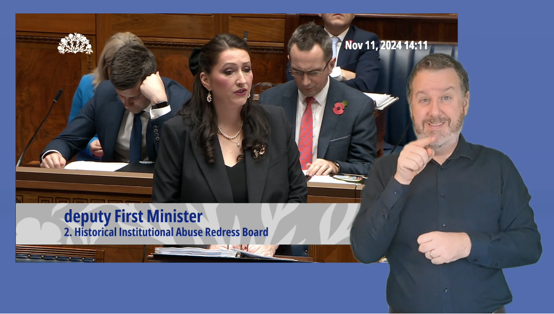 Emma Little Pengelly answering Members questions in the Assembly Chamber. In the foreground we see an ISL interpreter providing interpretation.