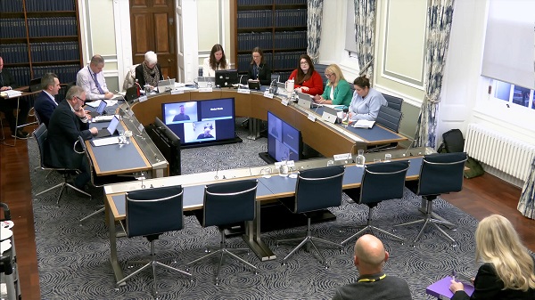 Members of the Justice Committee sitting in a committee room in Parliament Buildings.