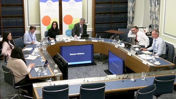 Members of the Committee sitting in a committee room in Parliament Buildings.