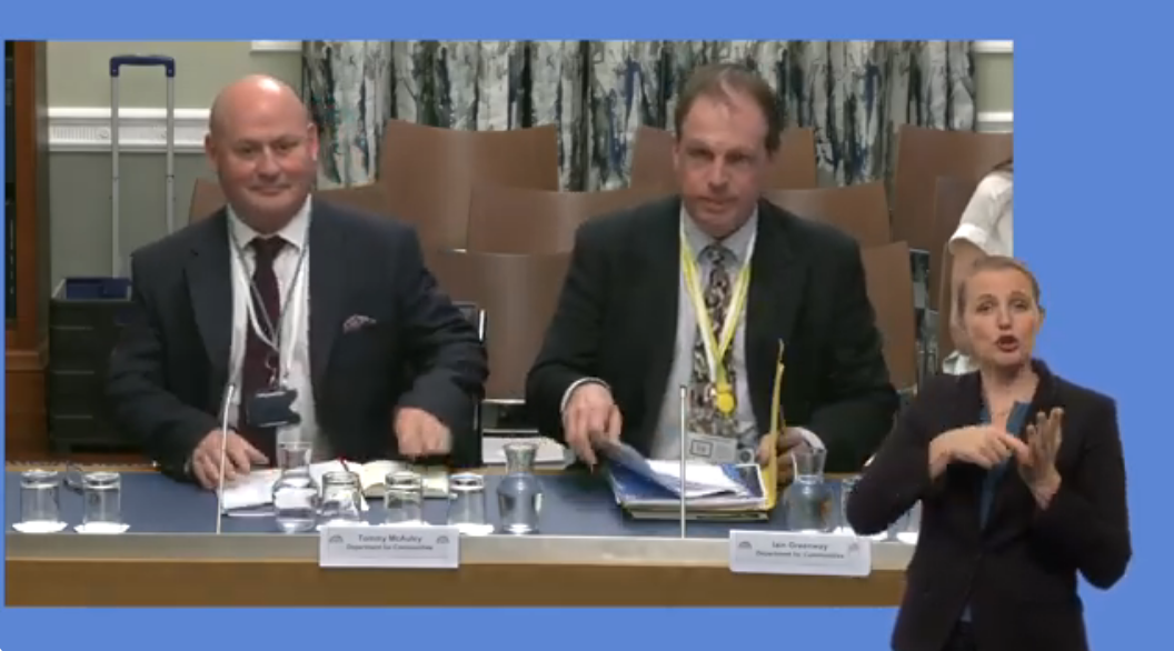 Representatives of teh Department for Communities providing evidence to the Committee for Communities on the progress of the Sign Language Bill. In the foregraound we see a BSL interpreter.